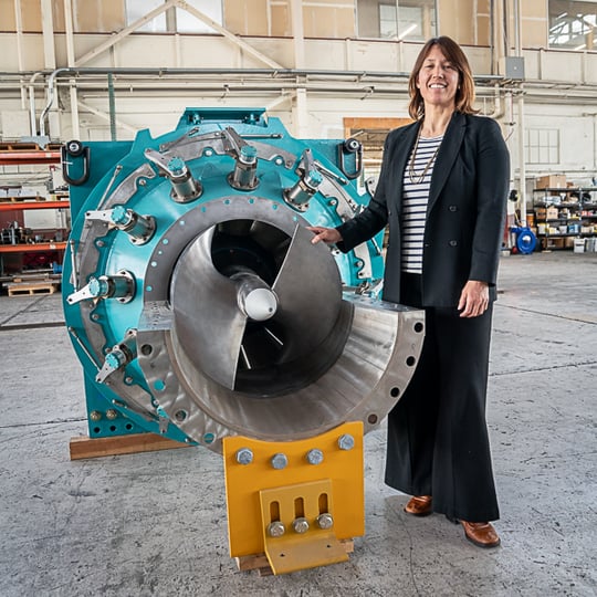Co-founder and CCO Gia Schneider with a FishSafe turbine at Natel headquarters in Alameda.